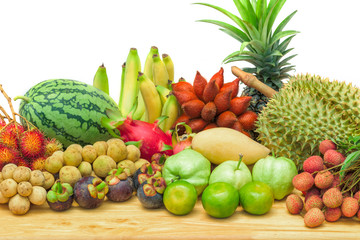 Fresh mixed fruits on wood table isolated on white background.