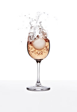 Rose wine in glass with splashes