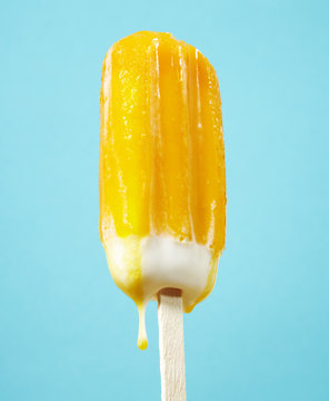 Yellow ice lolly dripping
