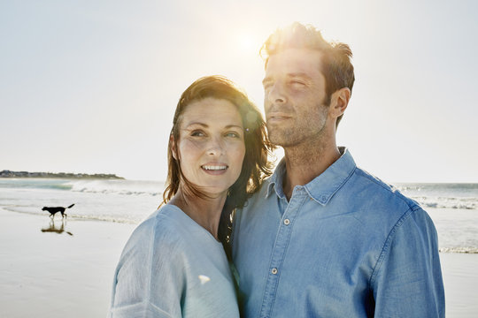 Couple on the beach at backlight