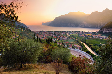 Scenic aerial view of Riva del Garda town, located on a shore of Garda lake, surronded by beautiful...