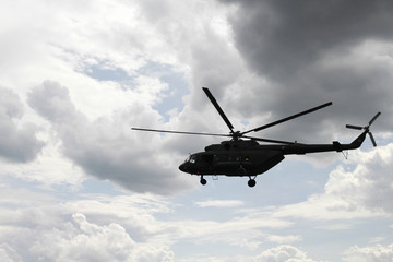 Fototapeta na wymiar Helicopter flying against the sky
