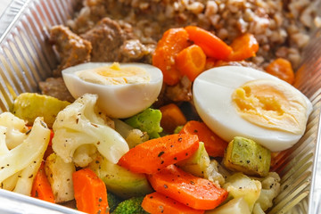 Healthy food take away in foil box, meat and vegetables