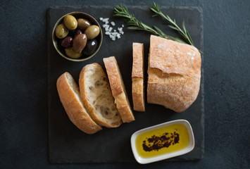 Olives, olive oil and Italian bread ciabatta - obrazy, fototapety, plakaty