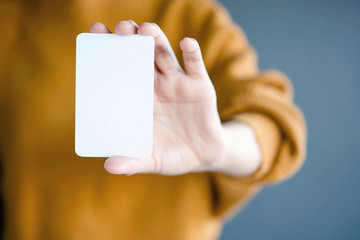 Woman holding blank business card