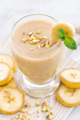 banana milkshake in a glass on white background, top view