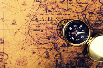 Fototapeta na wymiar compass on old vintage world map with copy space