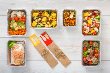 Healthy food take away in boxes, top view at wood