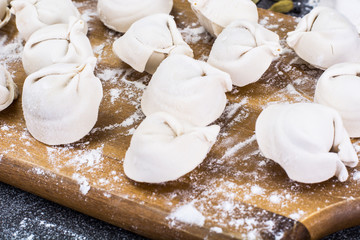 Cooked ravioli on the board with flour
