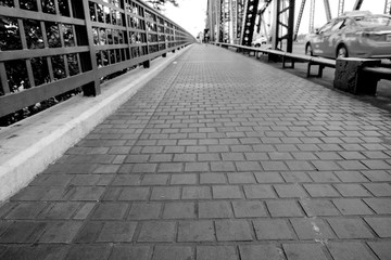 Pathway / View of pathway paved with stone block on the bridge. Shallow depth of field. Black and white tone.