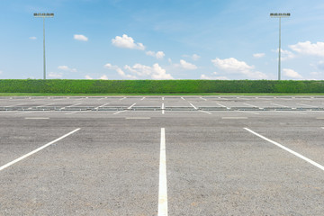 Fototapeta premium Empty parking lot against a beautiful blue sky
