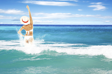 woman in swim suit and waves 