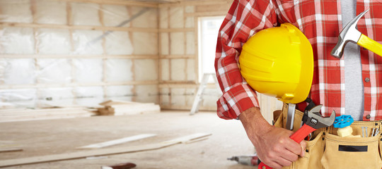 Builder handyman with construction tools.