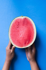 hands holding melon on blue color background - popart tropical design