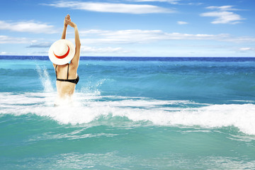 waves on sea and woman in bikini 