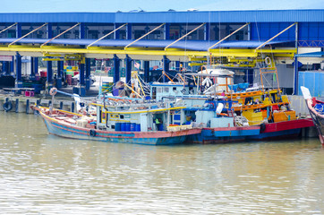 Fototapeta na wymiar JOHOR, MALAYSIA - JANUARY 30, 2017: Fishing boats anchored at the jetty during the monsoon season at Endau, Johor, Malaysia. Endau is one of the most important fisheries in Johor.