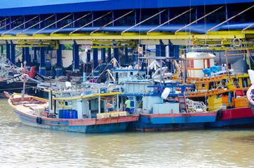 JOHOR, MALAYSIA - JANUARY 30, 2017: Fishing boats anchored at the jetty during the monsoon season at Endau, Johor, Malaysia. Endau is one of the most important fisheries in Johor.