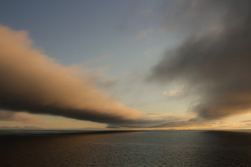 Obraz premium Low clouds over the sea at sunset