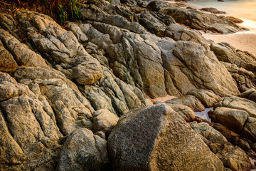 background and texture of break granite stone at Naiharn Beach,