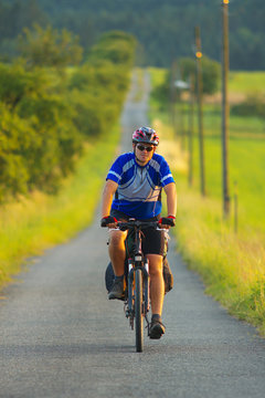 A tourist on a bicycle on the road