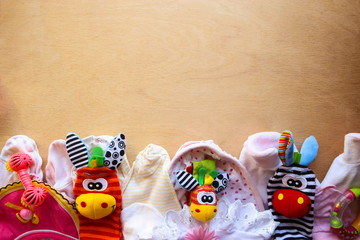 Детские игрушки,одежда обувь на деревянном фоне
