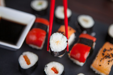 Sushi held in chopsticks