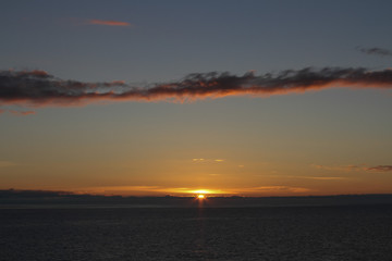 Naklejka premium Clouds at sunset over the sea, sunset over the sea