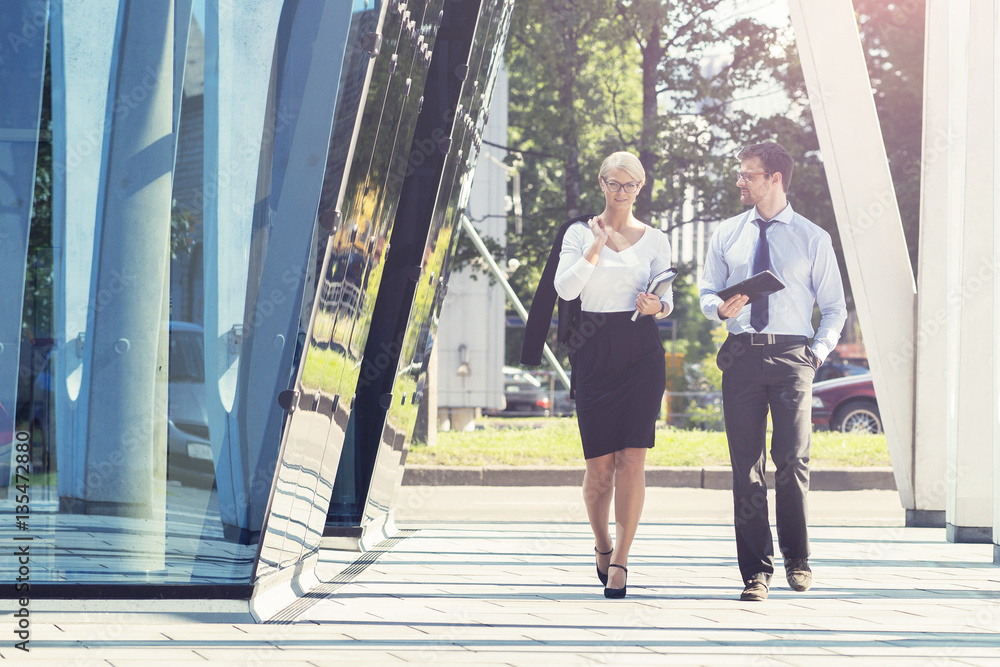 Wall mural man and woman in formalwear in the street. businessman and businesswoman. outdoor business concept.