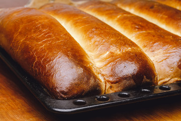 Hot, fresh baked homemade sweet pies, strudel on baking pan.