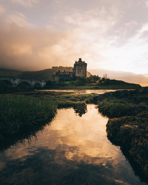 Scenic view of lake with castle during sunset