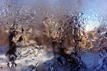 freezing water on glass closeup.