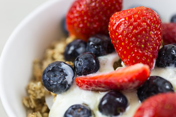 Yogurt and fruit breakfast cereal closeup
