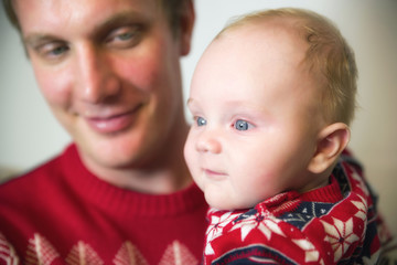 Smiling baby in hands of father