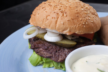 sandwich with cutlet, pickled cucumber and leaf lettuce