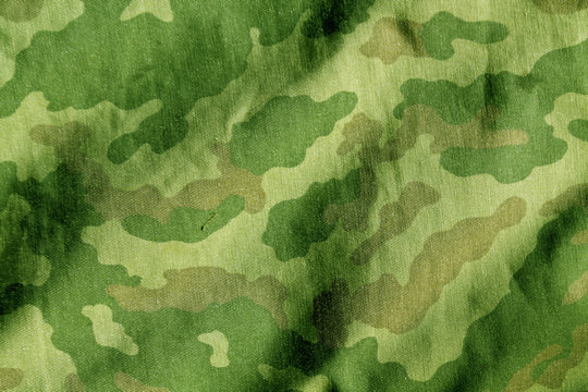 Weathered camouflage cloth texture.