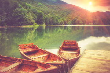 View of glacial mountain Lake Biogradsko, wooden pier and boats in forest. Biogradska Gora National...