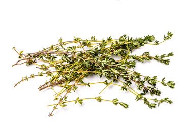 Fresh thyme sprigs lie on a white background, not isolated.