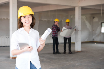 Close up woman Construction engineer wear yellow safety helmet w