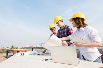 three construction engineers working outdoors in construction si