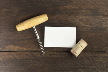 Photo of wine corkscrew and cork with business card