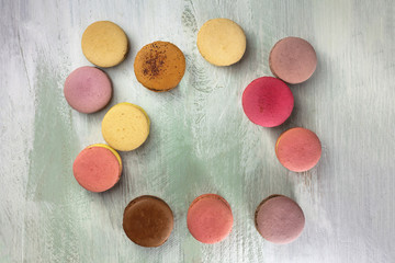 Macarons forming frame on vibrant purple texture