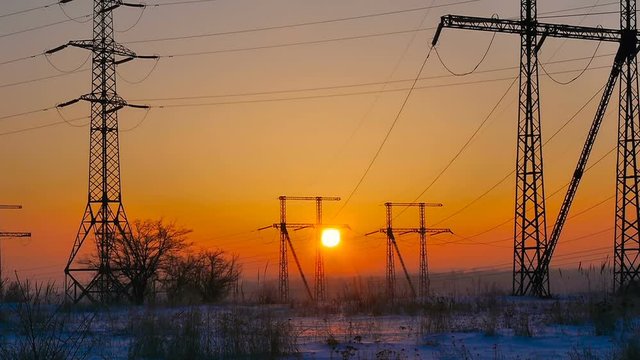 High-voltage power lines at sunrise. Sunrise and power lines