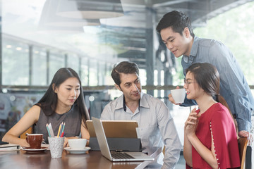 4 people meeting in coffee shop, business casual conceptual