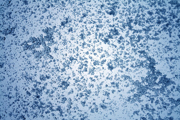 Fototapeta na wymiar Snow on blue toned window surface.