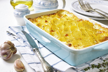 Potato gratin in a blue baking dish.Vintage style.
