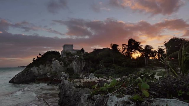 establishing shot of mayan tulum site at sunset