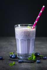 Blueberry milshake in glass.