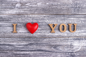 I love you, wooden lettering, gray  background, postcard Happy Valentine day, flat lay