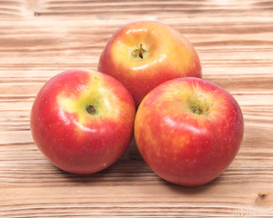 Ripe organic kanzi apple on vintage wooden tray