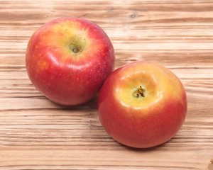 Ripe organic kanzi apple on vintage wooden tray